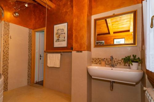 a bathroom with a sink and a mirror at Villa Salvia with pool in Ružići