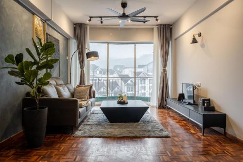 a living room with a couch and a table at Star Regency by Plush in Brinchang