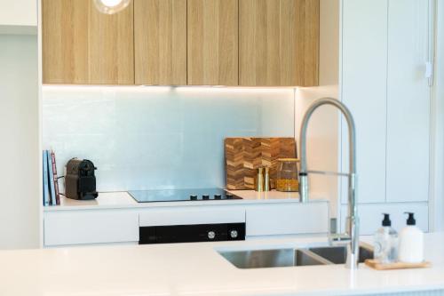 a kitchen with a sink and a counter top at Escape to Serenity by Experience Jervis Bay in Huskisson