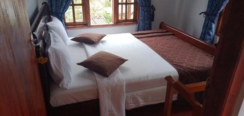 a bedroom with a bed and a window at The Train View in Nuwara Eliya