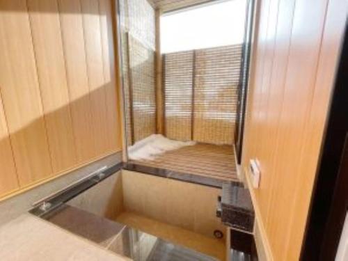 a small bathroom with a mirror and a window at Niseko White Villas1 in Niseko