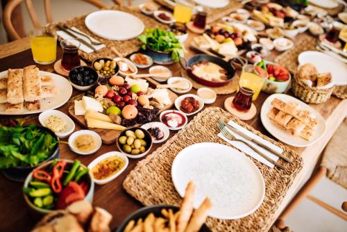 a table filled with plates of food and snacks at Enso Alaçatı in Cesme