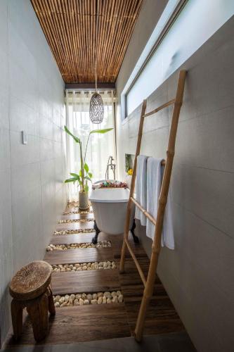 a bathroom with a bath tub and a sink at Ahana Resort El Nido in El Nido
