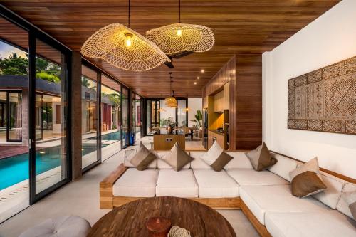 a living room with a couch and a table at Villa Livia by BaliSuperHost in Ubud