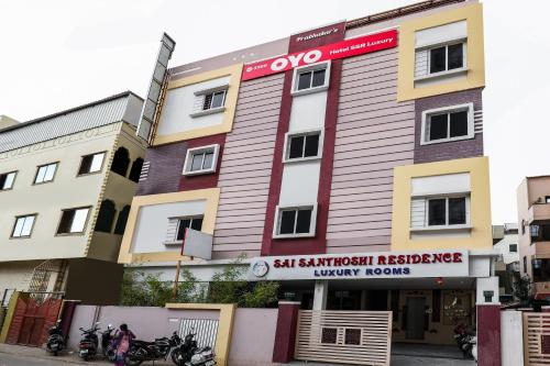 a building with motorcycles parked in front of it at OYO Ssr Luxury Rooms in Lingampalli