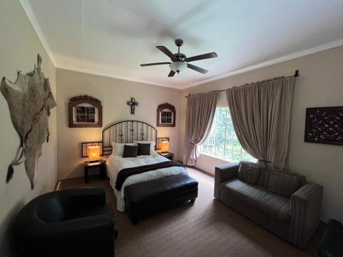 a bedroom with a bed and a ceiling fan at Big Tree Midrand in Midrand