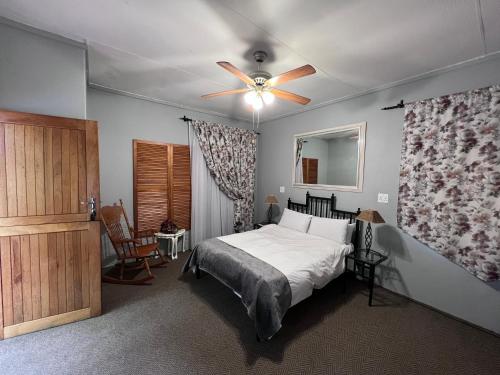 a bedroom with a bed and a ceiling fan at Big Tree Midrand in Midrand