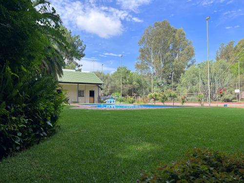 a yard with a swimming pool and a house at Big Tree Midrand in Midrand