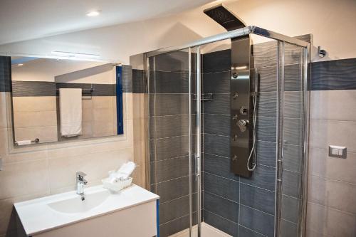 a bathroom with a shower and a sink at Karma Resort in Venetico