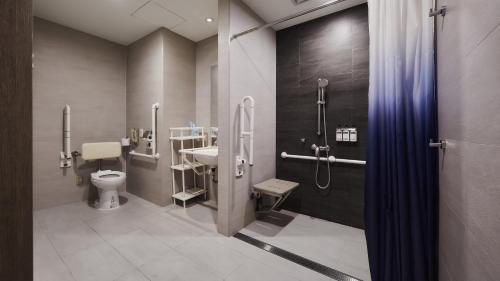 a bathroom with a toilet and a sink at Holiday Inn Express Taichung Park, an IHG Hotel in Taichung