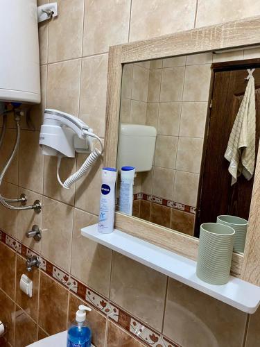 a bathroom with a mirror and a sink at Apartman Stefan Zlatibor in Zlatibor