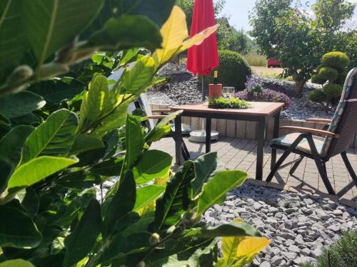 a patio with a table and two chairs and an umbrella at Ferienwohnung Moselzeit in Alken