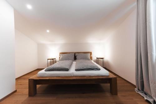 a bed in a room with a white wall at Sunny Mountain in Münster