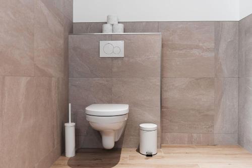 a bathroom with a white toilet in a room at Sunny Mountain in Münster