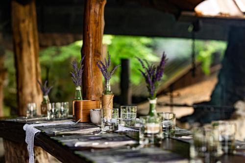 a table with glasses and vases on it at Bacówka Biały Jeleń in Iwkowa
