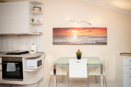 una cucina con tavolo, tavolo e forno a microonde di 063 - Casa del Corso, Centrale 200m dal mare e spiaggia a Sestri Levante