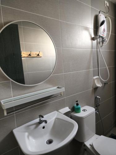 a bathroom with a sink and a mirror and a toilet at SCANDI HOMESTAY IPOH muslem in Ipoh