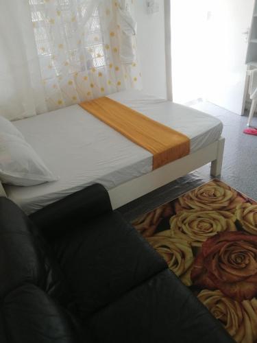 a bedroom with a bed and a couch at Mombasa City Center Studio in Mombasa