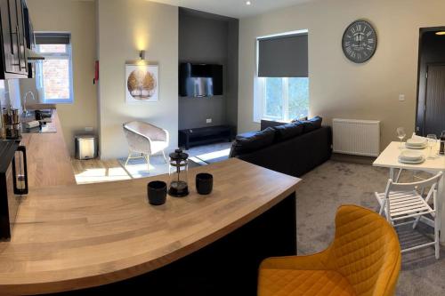 a living room with a large wooden island in the middle at Modern 1BR Apartment near Loughborough University & Hospital in Loughborough