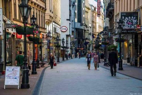 a group of people walking down a city street at Budapest City Centre Studio - Contactless Check In in Budapest