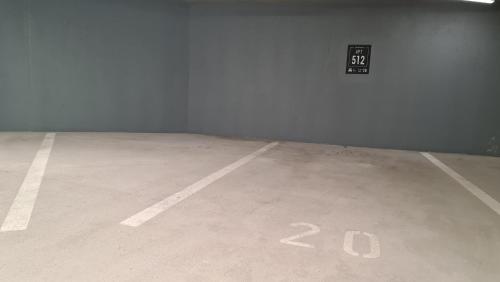 an empty parking lot with a speed limit sign on the wall at Unique View Design Apartment Štrbské Pleso in Štrbské Pleso
