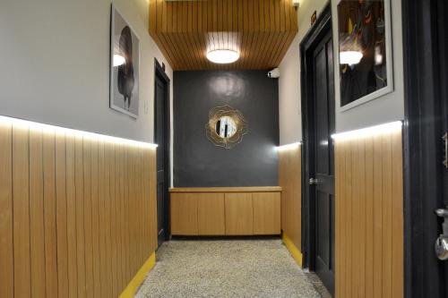 a hallway with wood paneling and a hallway with doors at PRINCE RESIDENCY CLUB HOUSE in Jamnagar
