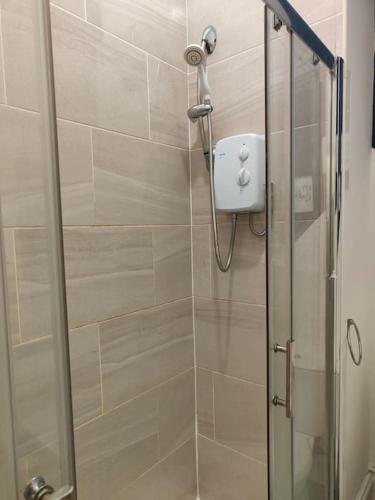 a shower with a glass door in a bathroom at Newhall Apartment in Birmingham