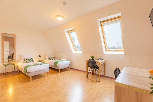 a room with a couch and a bed and a desk at Appart’City Confort Nantes Centre in Nantes