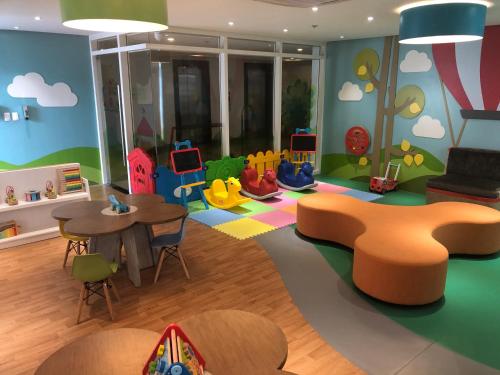 a childrens play room with a table and chairs at Lafayette Park Square Condominium Megaworld in Iloilo City