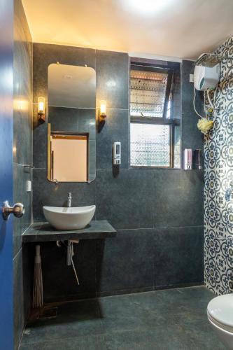 a bathroom with a sink and a mirror at SaffronStays Apricus Farm, Karjat in Karjat