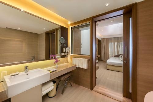 a bathroom with a sink and a mirror at The Resort in Mumbai