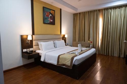 a hotel room with a bed and a window at Hyphen Premier-Business Hotel in Meerut