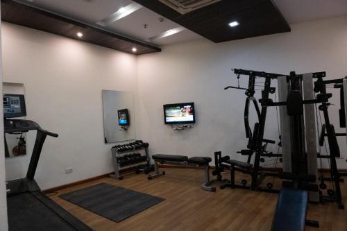 a room with a gym with tread machines at Hyphen Premier-Business Hotel in Meerut