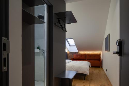 a bedroom with a couch and a window in a room at Dunten Hotel in Tallinn