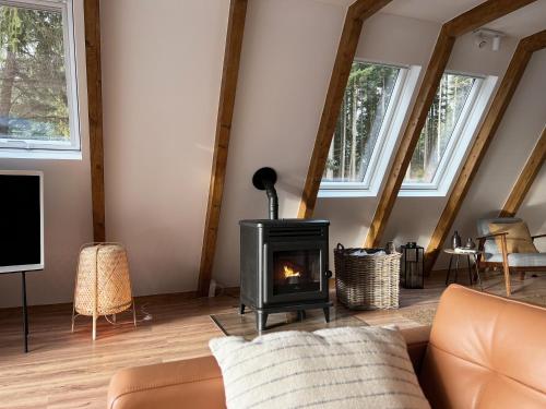 a living room with a fireplace and a couch at Design Chalet Vulkaneifel in Kerschenbach