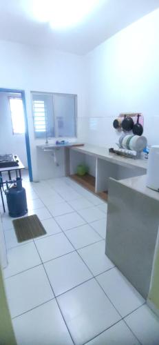 a kitchen with a white tiled floor and a counter at Al Irfan Homestay Tmn SgDua Utama in Butterworth