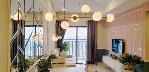 a living room with a couch and chairs and a television at Tommy Homes in Soho Residence Central District 1 in Ho Chi Minh City