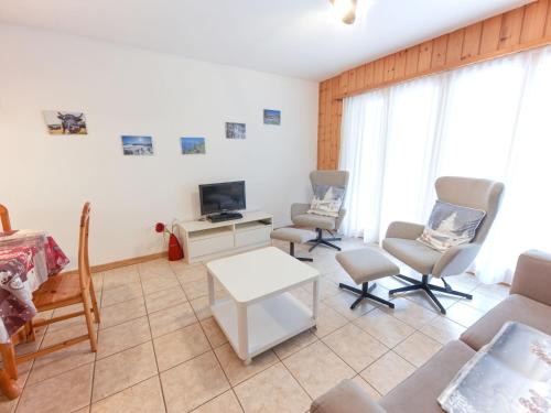 a living room with a couch and chairs and a tv at Apartment Sérandes 2 by Interhome in Les Collons