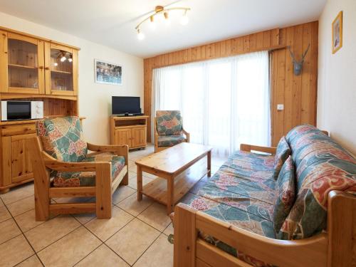 a living room with a bed and a couch and a table at Apartment Sérandes 9 by Interhome in Les Collons
