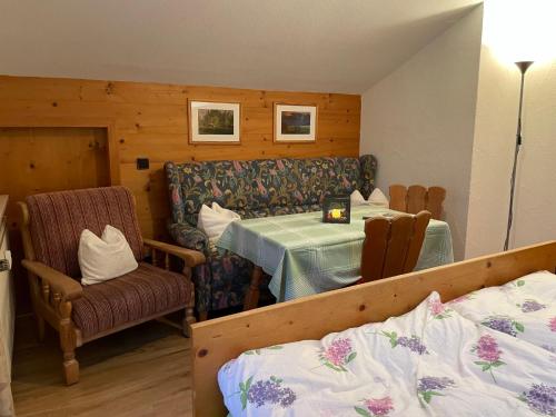 a bedroom with a table and a chair and a bed at Apartment Kramer by Interhome in Farchant