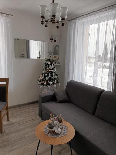a living room with a couch and a christmas tree at Domček v záhrade in Liptovský Mikuláš