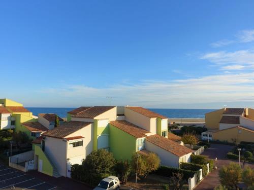 a row of houses with the ocean in the background at Apartment Les Balcons de la Méditerranée-2 by Interhome in Narbonne-Plage