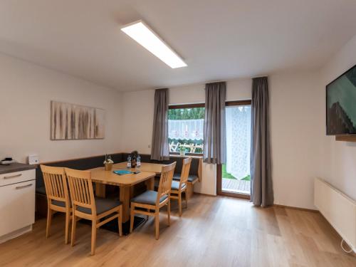 a kitchen and dining room with a table and chairs at Apartment Alpenchalets - ZSE204 by Interhome in Zell am See