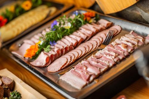 a bunch of different types of food on a tray at Bacówka Biały Jeleń in Iwkowa