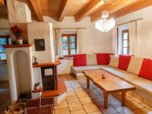 a living room with a couch and a fireplace at Holiday Home Waldhaus by Interhome in Fernsdorf