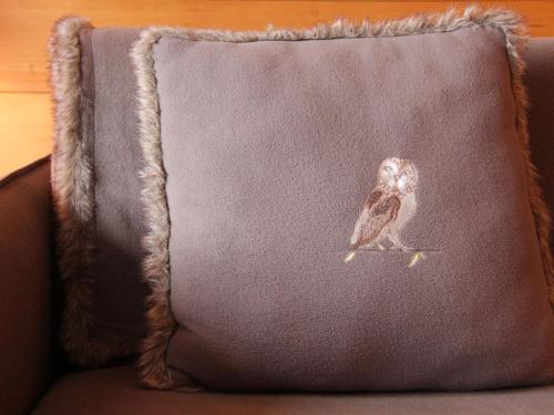 an owl sitting on a pillow on a couch at Apartment Grand-Hôtel B35 by Interhome in Villars-sur-Ollon