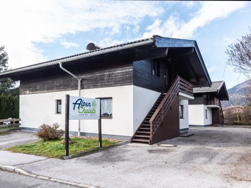 a building with a sign that reads alaskan village at Apartment Alpenchalets - ZSE202 by Interhome in Zell am See