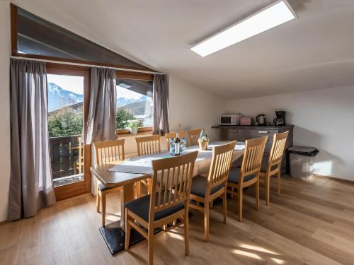 a kitchen and dining room with a table and chairs at Apartment Alpenchalets - ZSE203 by Interhome in Zell am See