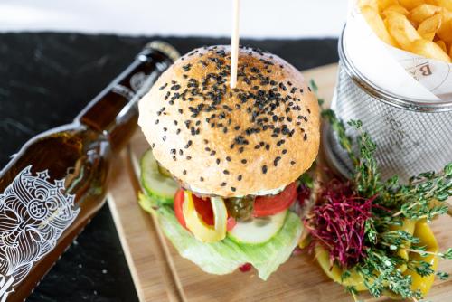 a sandwich and french fries on a cutting board at Bacówka Biały Jeleń in Iwkowa