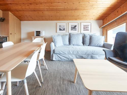 a living room with a couch and a table at Apartment Le Hameau-7 by Interhome in Les Collons